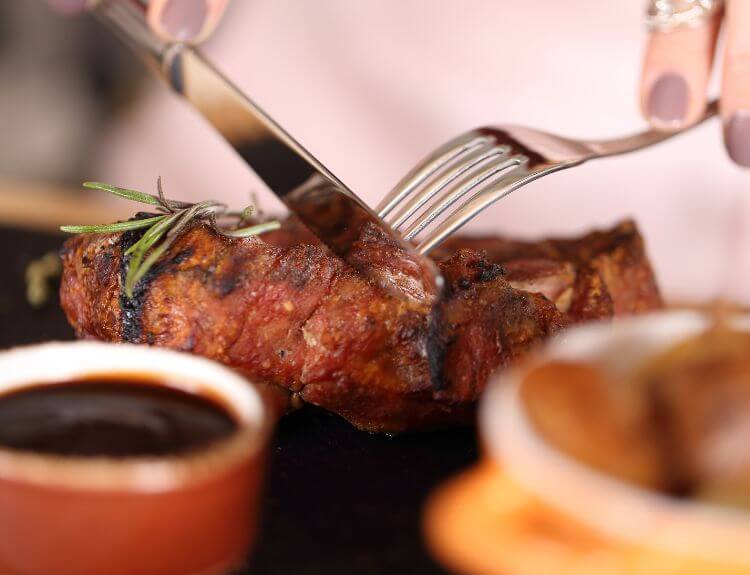 Guests enjoying a prix-fixe dinner during Edmonton Downtown Dining Week at a busy downtown restaurant.