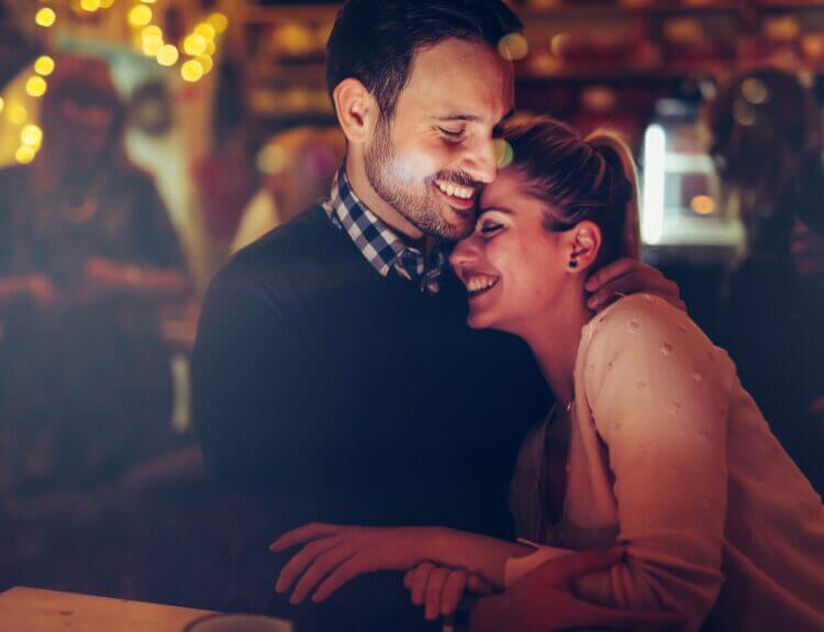 Couple enjoying a romantic date night in Edmonton at a restaurant