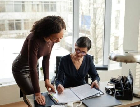Two professional women working together on lifestyle management and concierge planning