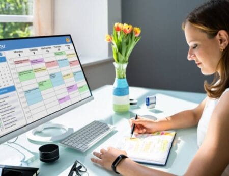 A person on their computer displaying a busy schedule, arranged by a personal concierge service.